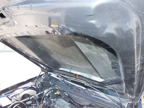 2003 Ford Crown Victoria - Close view beneath a propped hood with detaching liner over the cowl and wiper area.