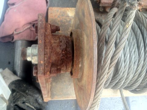 2000 Jeep Wrangler - Close-up view of a rusty winch drum and its steel cable, likely part of an off-road vehicle accessory.