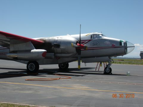 1996 Ford Bronco - This twin-engine aircraft is parked on an airport tarmac under a clear blue sky.