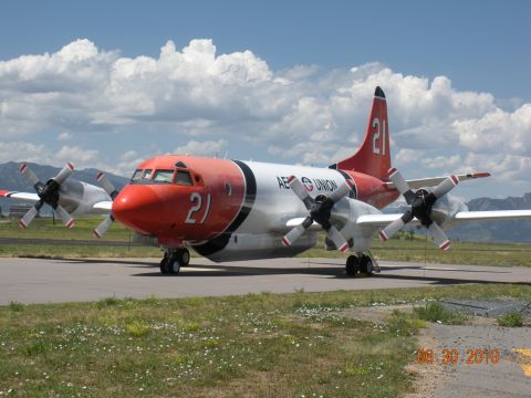 1996 Ford Bronco - A Lockheed P-3 Orion aircraft sits on the tarmac under a cloudy sky.