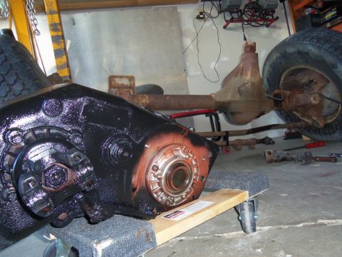 1968 Ford Bronco - A vehicle's transfer case and rear axle assembly are shown in a garage setting.