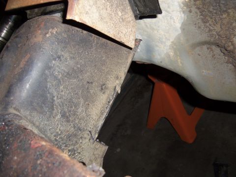 1968 Ford Bronco - Undercarriage view showing frame and suspension parts, supported by an orange jack stand.