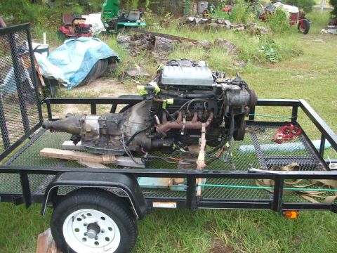 1966 Ford Ranchero - A disassembled engine and transmission unit is transported on a utility trailer, with a "SUPER MOTORS" watermark at the bottom right.