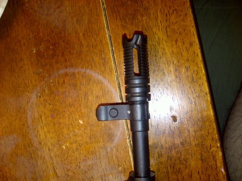 1989 Ford Bronco - Close-up of the muzzle device on a Chinese Paratrooper SKS rifle, resting on a wooden surface.