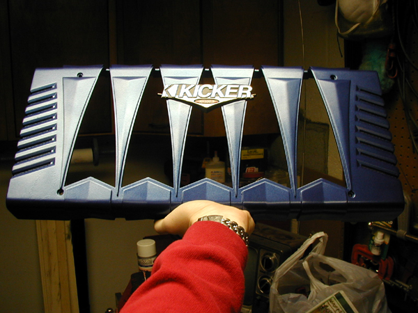Blue Kicker amplifier or speaker grille held in a hand