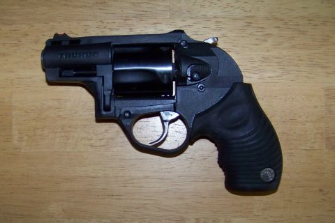 1994 Ford F-150 - Close-up of a black Taurus revolver, showing its cylinder and trigger mechanism.