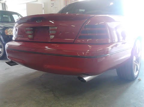 1999 Ford Crown Victoria - Rear view of a red 1998 Ford Crown Victoria, showing its distinctive taillights and dual exhaust pipes.