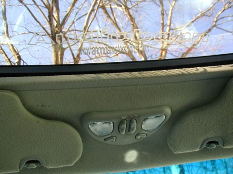 1998 Ford Taurus - Interior view showing the overhead console, sun visors, and windshield with reflections.