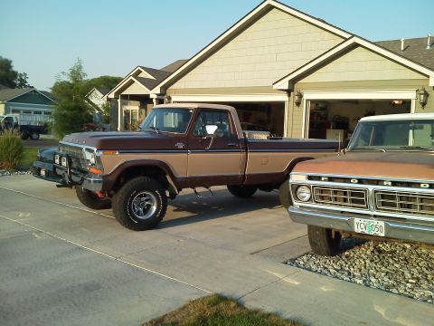 1979 Ford F-150 - Two Ford pickup trucks are parked in front of a suburban house and garage.