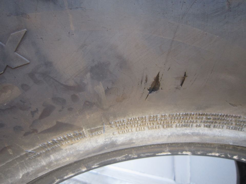 Close-up of tire sidewall showing text and scratches