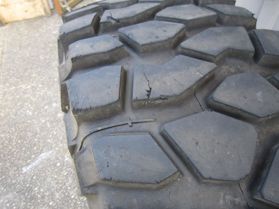 close-up of a worn off-road tire tread with visible cracks