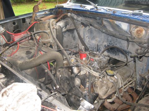 1994 Ford Bronco - Engine bay of a 1994 Ford Bronco, showing the engine and various hoses and wires.