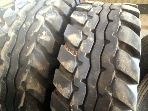 2000 Jeep Wrangler - Close-up view of two large, off-road tires with aggressive tread patterns.