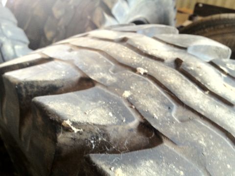 2000 Jeep Wrangler - Aggressive off-road tire tread detail, with Supermotors.net logo in the corner.