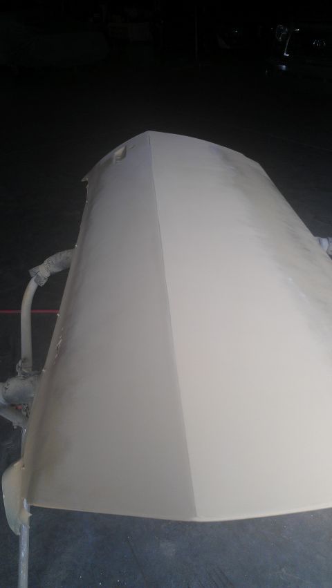 1973 Chevrolet Camaro - A car hood is prepared for painting, showing a primer coat and a high-angle perspective.