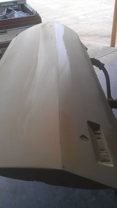 1973 Chevrolet Camaro - Car hood undergoing bodywork, showing primer and filler application.
