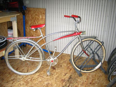 1994 Ford Bronco - This vintage bicycle has a chrome frame, red seat, and red handlebars.