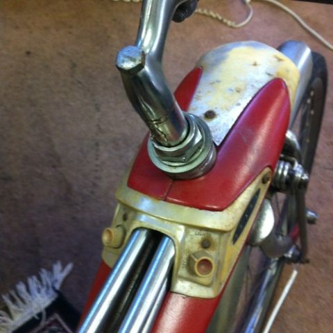 1994 Ford Bronco - A close-up view of the handlebars and front fairing of an old bicycle.
