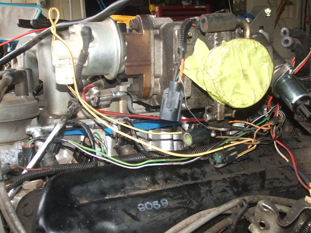 Engine parts and wiring harness with yellow tape on a component