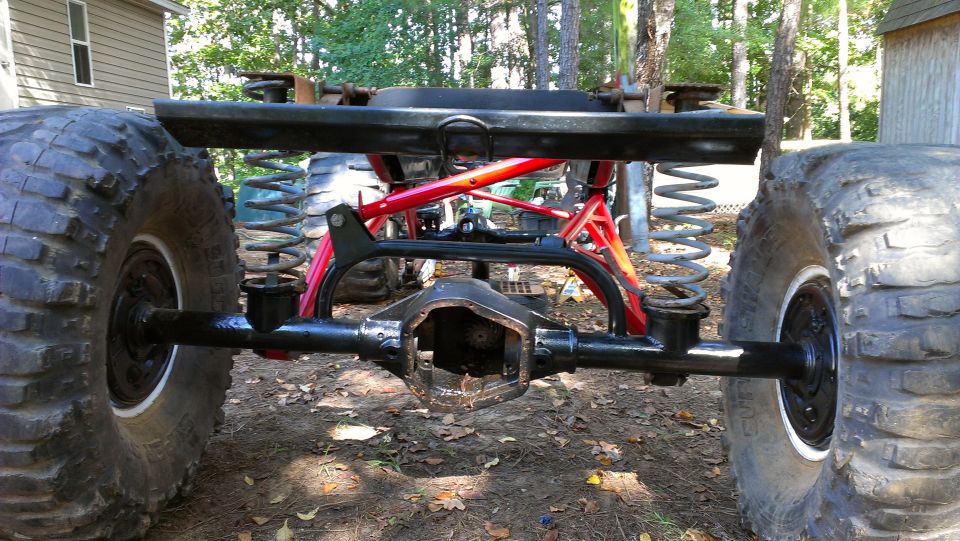 Rear axle and suspension components of a heavily modified off-road vehicle with large tires