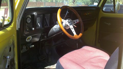 1978 Ford Bronco - The interior of a 1978 Ford Bronco features a custom wood-rimmed steering wheel and a classic dashboard layout.
