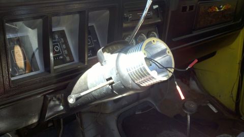 1978 Ford Bronco - The steering column has been removed, revealing the wiring and dashboard of the vehicle's interior.