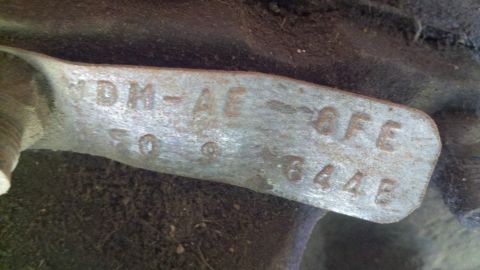 1978 Ford Bronco - Close-up of a metal identification tag with stamped alphanumeric characters.