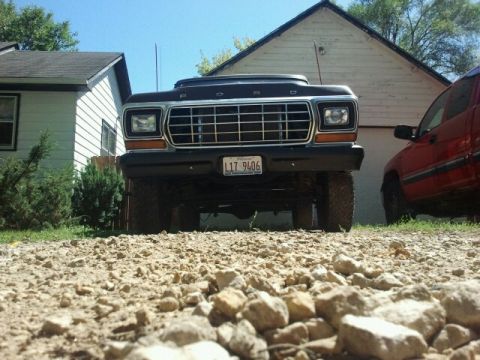 1979 Ford Bronco - This 1979 Ford Bronco features a lifted suspension and off-road tires, presented in a low-angle front view.