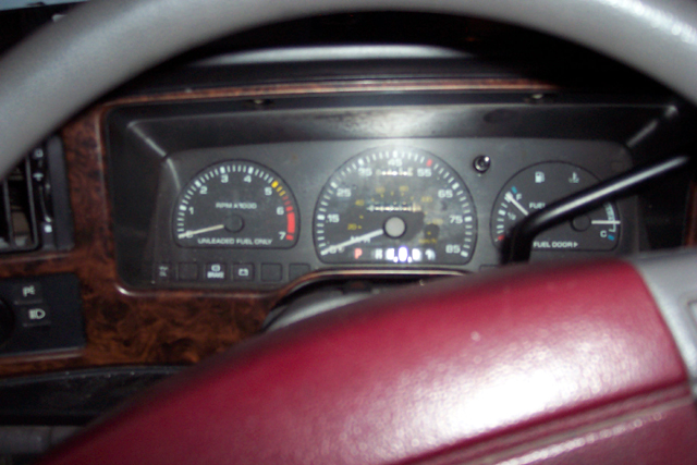 Instrument cluster with tachometer, 85-mph speedometer, and fuel/temp gauges seen through steering wheel