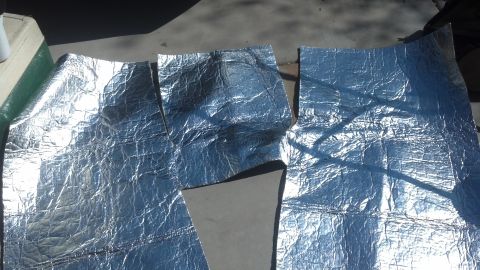 1995 Ford Bronco - Sound deadening material is laid out on a concrete surface, possibly for installation.