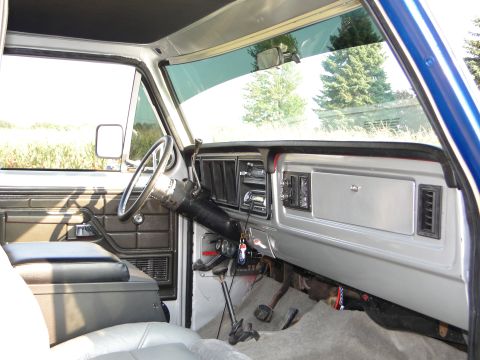 1978 Ford Bronco - The interior of a 1978 Ford Bronco shows a dashboard with a radio, vents, and a column shifter.