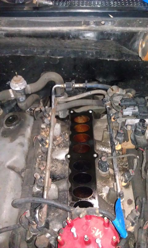1993 Ford Bronco - Close-up view of a vehicle's engine, focusing on the intake manifold and associated components.