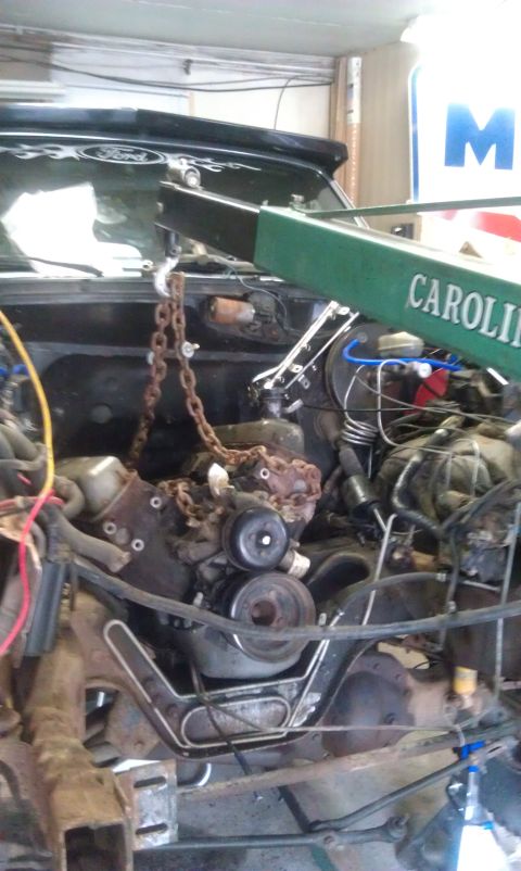 1993 Ford Bronco - Engine hoist is positioned to lift the engine from the 1993 Ford Bronco's engine bay.