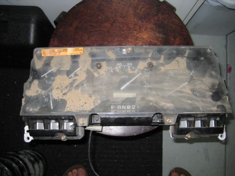 1996 Ford Bronco - A dirty instrument cluster is shown, likely removed from a vehicle for repair or replacement.