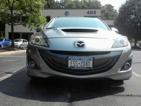 2010 Mazda 3 - Front view of a 2010 Mazda 3 parked outside an office building.