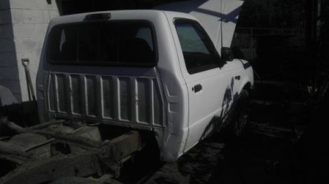 1987 Ford Ranger - This 1987 Ford Ranger pickup truck is shown from the front three-quarter view with its hood open.