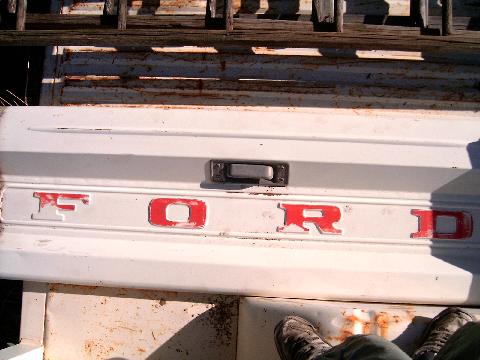 1967 Ford F-250 - Rear view of a white Ford tailgate with red lettering, likely from a 1967 F-250.
