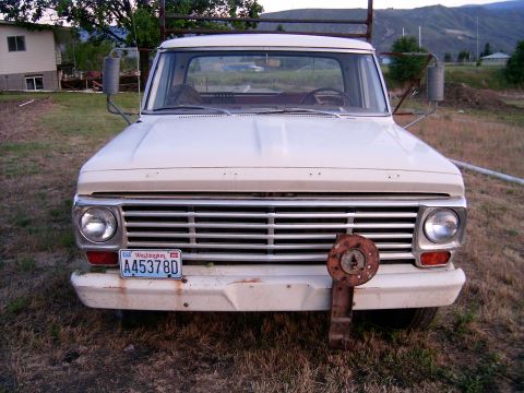 1967 Ford F-250 - This 1967 Ford F-250 pickup truck is parked outdoors with a rusty metal object attached to the front bumper.