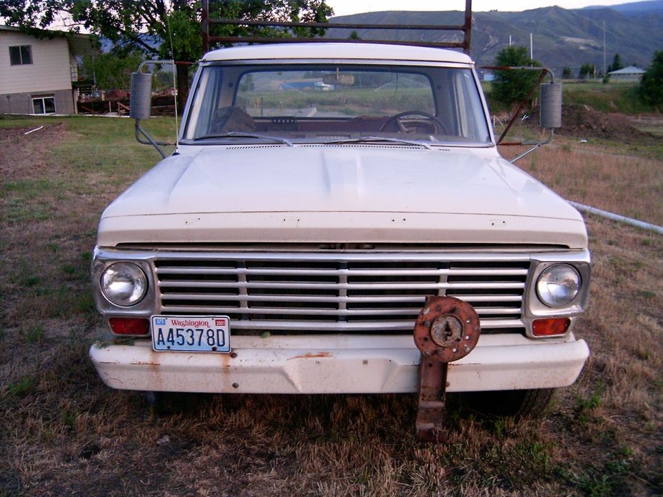 Front view of a 1967 Ford F-250 pickup truck with a chrome grille and Washington plates