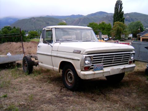 1967 Ford F-250 - A white 1967 Ford F-250 truck is parked outdoors with a bare frame extending from its rear.