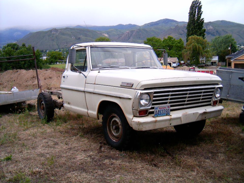 White 1967 Ford F-250 truck, front 3/4 view, with a bare frame extending from the rear