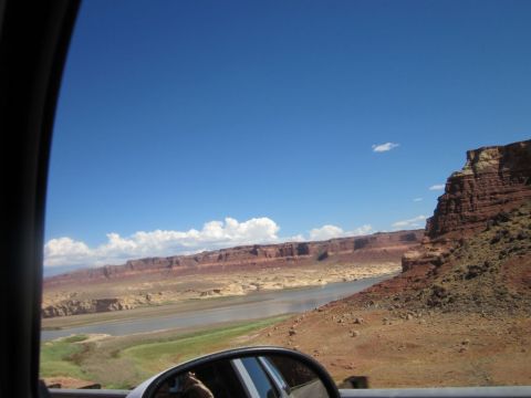 1991 Ford LTD Crown Victoria - A vast desert landscape unfolds, with a winding river cutting through arid terrain beneath towering red rock formations.