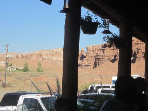 1991 Ford LTD Crown Victoria - A white truck and bus are visible in the foreground with the iconic red rock formations of Monument Valley in the background.