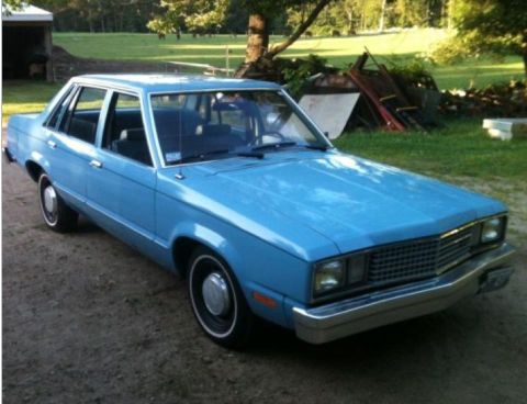 2004 Ford Crown Victoria - This blue sedan, likely a 1978 Ford Fairmont, is shown from a 3/4 front angle.