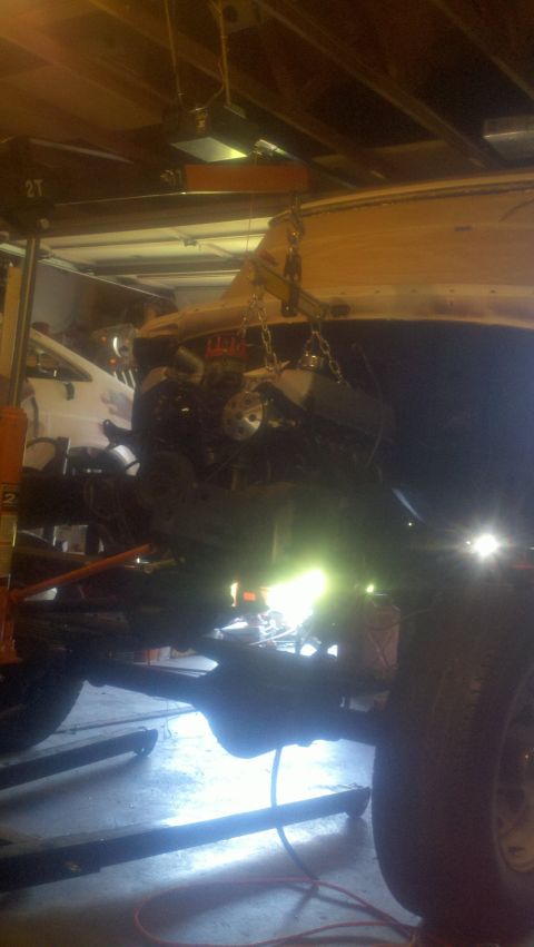 1967 Ford F-250 - Engine removal in progress, showing the vehicle's undercarriage and suspension components.