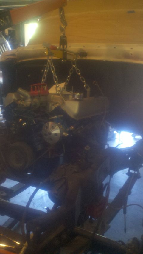 1967 Ford F-250 - An engine is being hoisted out of a vehicle with a crane and chains.
