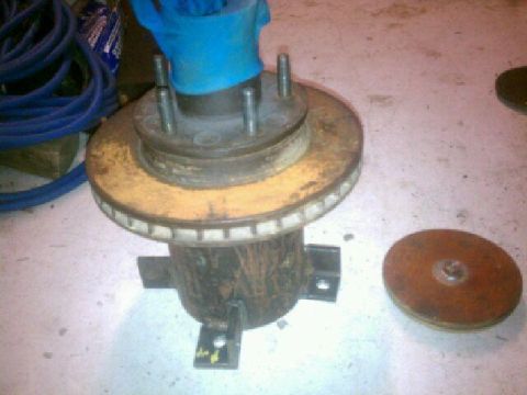 1984 Ford Bronco - A brake rotor and hub assembly is shown, with a separate rotor nearby.
