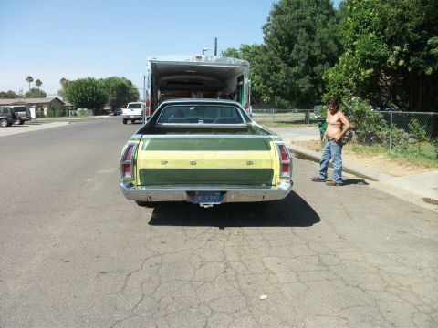 1972 Ford Ranchero - The rear of a 1972 Ford Ranchero shows its distinctive two-tone paint scheme and a trailer hitched to its bumper.