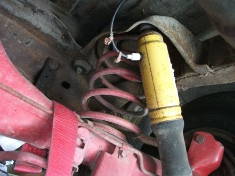 1972 Ford Ranchero - Close-up of the rear suspension system, showing the shock absorber and coil spring assembly.