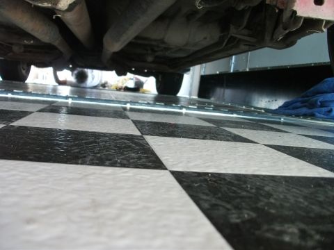 1972 Ford Ranchero - View from below a vehicle, showing the exhaust system and floor.